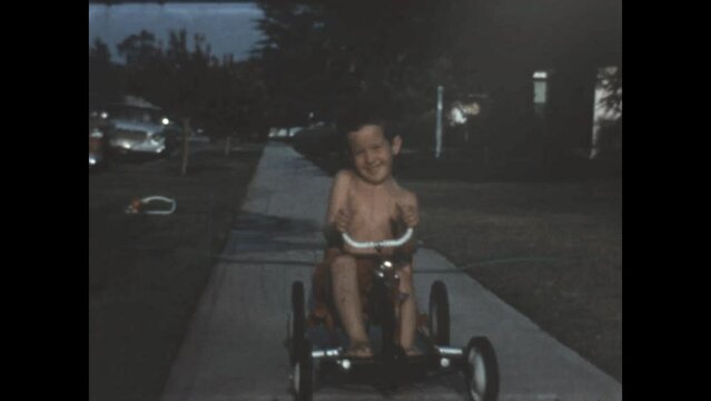 Riding on the Sidewalk 1963 - A boy pedals his go kart on the sidewalk in Canoga Park, California in 1963. 