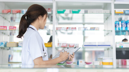 Pharmacist working in a pharmacy, Consultation and medical advice, All kinds of generic household drugs and pharmaceutical products on the shelf, Service and assistance to patients, Pharmacy.