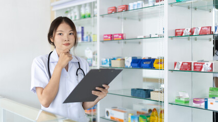 Obraz na płótnie Canvas Pharmacist working in a pharmacy, Consultation and medical advice, All kinds of generic household drugs and pharmaceutical products on the shelf, Service and assistance to patients, Pharmacy.