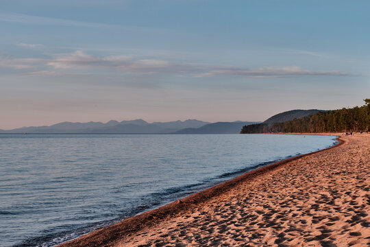 Sandy beach before sunset near Maksimikha village, Buryatia, Russia. Barguzinsky Bay of Lake Baikal.