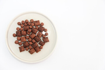 children's dry chocolate breakfast balls and pads in a decorative ceramic plate
