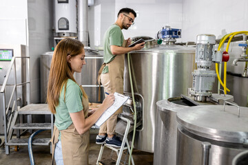 Man and woman working in craft brewery.