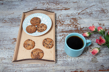 coffee with delicious chocolate biscuits on the table