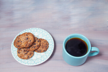 coffee with delicious chocolate biscuits on the table