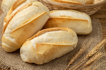 French bread, salt bread or pistolet over wooden table