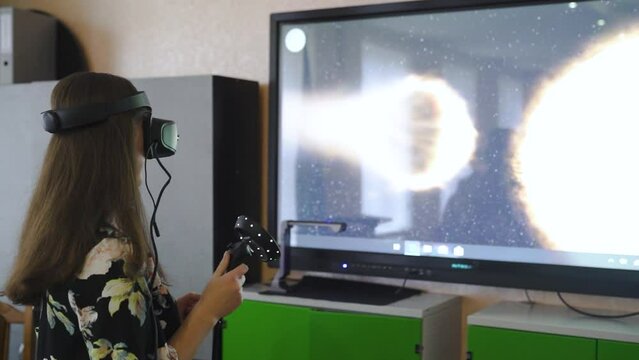 Schoolgirl using 3d vr glasses during interactive lesson in school classroom.