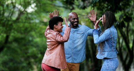 Three people celebrating success uniting group. African ethnicity