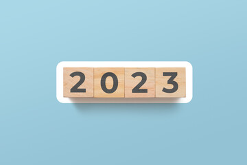 2023 wooden cubes on blue background