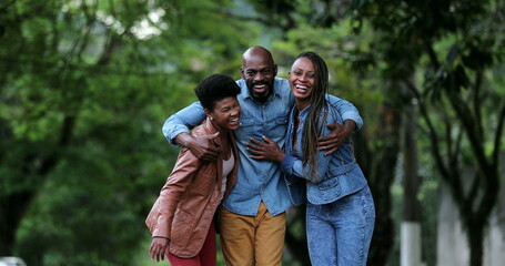 Fototapeta premium Three happy people posing together. African ethnicity, friends smiling