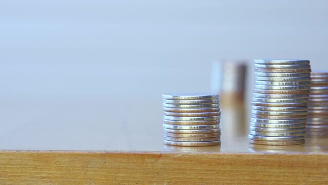 Man's hand put money coins to stack of coins. Money, Financial, Business Growth concept.