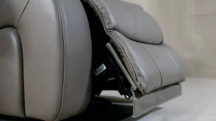 modern fold-out recliner chair with automatic mechanism for lift legs, details view in showroom