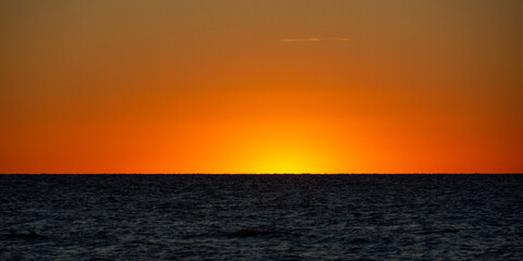 Light on the horizon over the sea after sunset