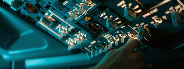 CU Commercial aircraft pilots adjusting radio channel parameters during the flight at high...