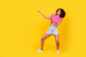 Full body profile portrait of impressed worried person arms wait catch look empty space isolated on yellow color background