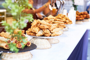 Bar counter with plates of sausages, croquettes and pasties and blur effect