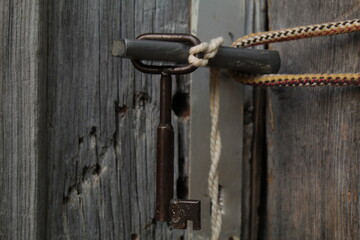 An old style vintage door key in hand