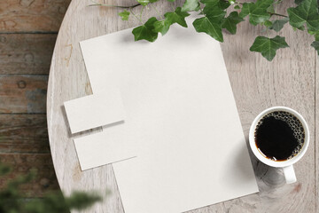 Clean minimal business card and paper A4 mockup on wooden table with plant