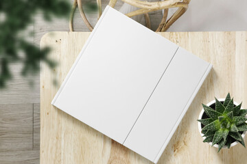 Clean minimal cover square book mockup on top wooden with plants
