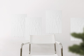 Clean minimal poster mockup on the white wall with chair and people