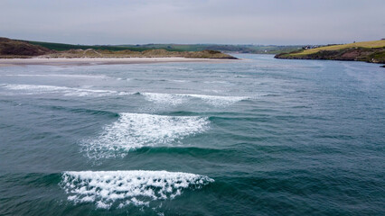 View of Inchydoney beach from the sea at high tide. Beautiful sea waves, surf. Aerial photo.
