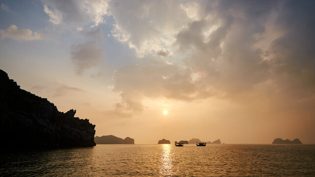 beautiful warm sunset sky over the islands in the azure sea. beautiful natural background. rocky islands in Vietnam. halong bay