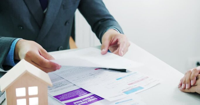 Businessman, saleman or agent to read, explain or review detail in document, agreement, contract for sale, rent, buy of home, house or residential building. Concept of business, real estate, property.