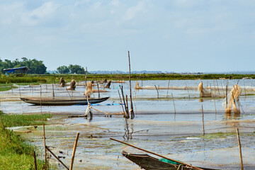 Fototapeta premium fishing boats and nets placed on bamboo sticks in a lake in southeast asia