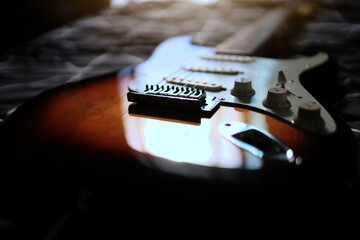 background picture for electric guitar and sunlight shining in the dark room. lonely and broken...