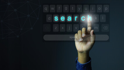 His hand reached up to press the keyboard  to searching for the information on the Internet with the word search icon appearing on the virtual keyboard.