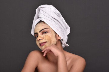 A young woman's face with home made face mask applied for skin care 