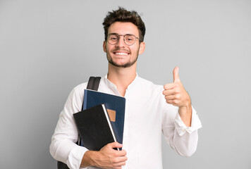 young handsome man isolated with a bag and books. university student concept