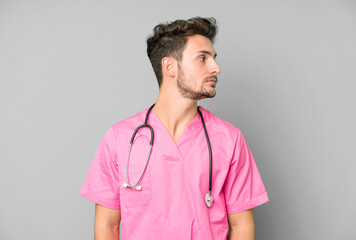 handsome teenager on profile view thinking, imagining or daydreaming. nurse concept