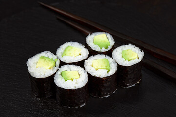 Set of tuna sushi rolls on black desk background
