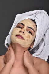 A young woman's face with home made face mask applied for skin care 