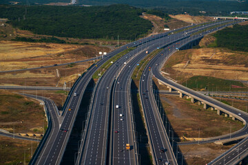Aerial traffic view of highways Interchange with transport vehicle move on road with natural country background