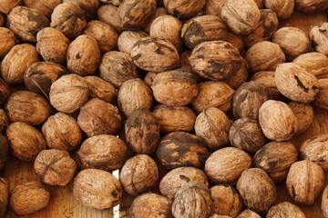 Some walnuts on a wooden bench 