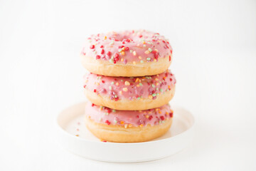 Pink donuts on a white background, close-up