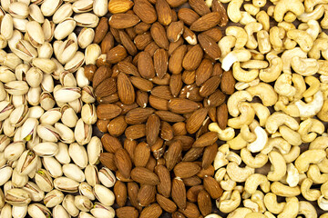 background of mixed nuts (almonds,  pistachio, cashews) 