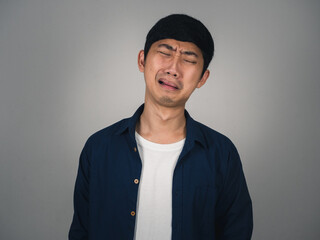 Obraz premium Asian man feels depressed and crying about unhappy life isolated