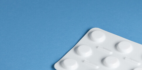 Medical banner. Blue background with a white pill blister on the side of the image with free space...