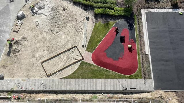 Workers At Construction Site Install A Rubber Coating.Time Lapse