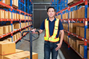 Asian male worker with boxes on cart trolley showing thumb up to guarantee of quality control at...