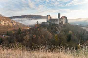 Hardegg medieval castle on a fortified hill upon Thaya river during summer or autumn time. Misty big ruins in the Thayatal Valley, National park, Lower Austria. The Smallest Austrian town.