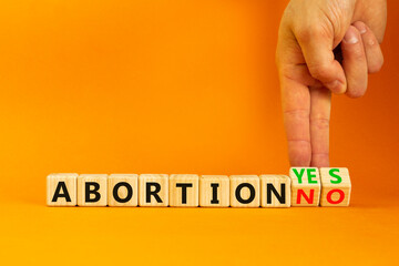 Abortion yes or no symbol. Concept words Abortion yes or Abortion no on wooden cubes. Doctor hand....