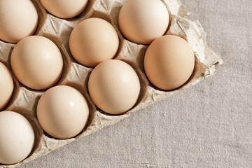 Fresh organic chicken eggs in carton pack or egg paper container on a sacking. Zero waste packaging concept