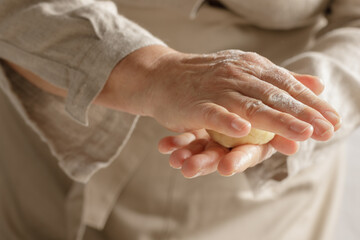 Women’s hands, flour and dough. A woman is preparing a dough for home baking. Concept of home cooking with organic and natural ingredients. Zero waste concept