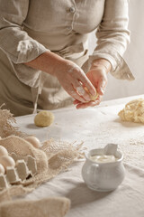 Women’s hands, flour and dough. A woman is preparing a dough for home baking. Concept of home cooking with organic and natural ingredients. Zero waste concept