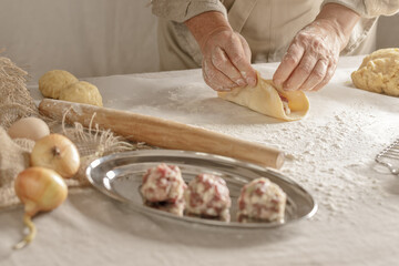 Women’s hands, flour and dough. A woman is preparing a dough for home baking. Concept of home cooking with organic and natural ingredients. Zero waste concept