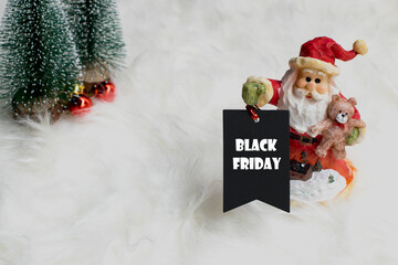 santa claus with a black friday tag.  Christmas background. Black friday concept.