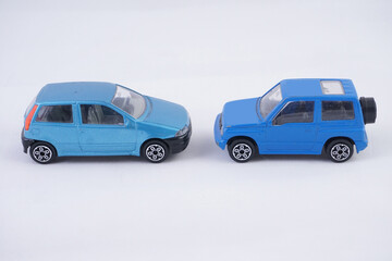 Two cars face to face, model, toys, symbolic meaning, isolated on the white background